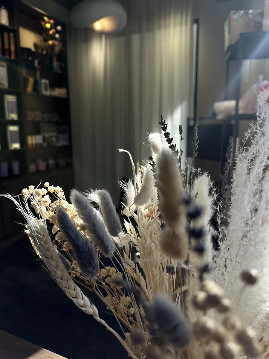 Interior of Dear Robert specialty tea shop — dried flowers on the counter and shelves with the collection